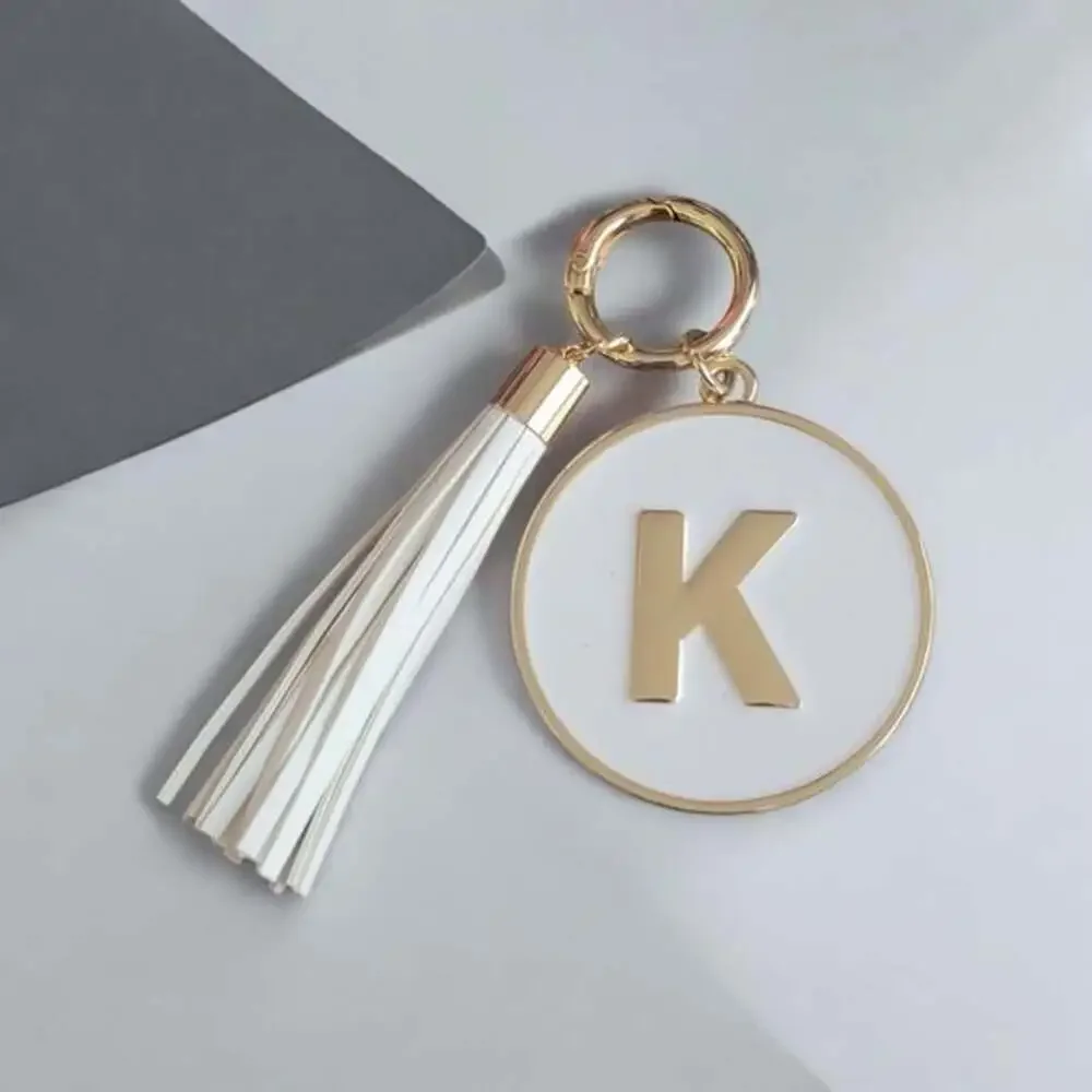 Gold and White K Keychain with Tassel